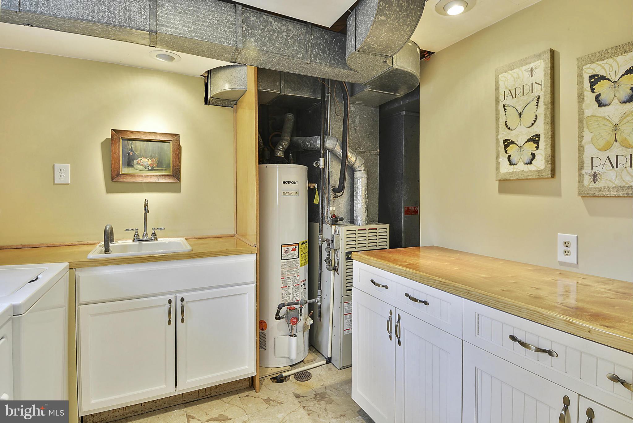 7405 Chatham Street Springfield, VA 22151 - Photo 26 of 30 a view of a kitchen with a sink and cabinets