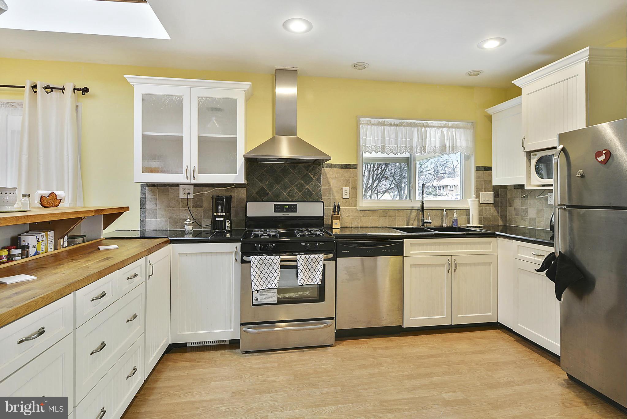 7405 Chatham Street Springfield, VA 22151 - Photo 8 of 30 a kitchen with granite countertop a refrigerator and a sink