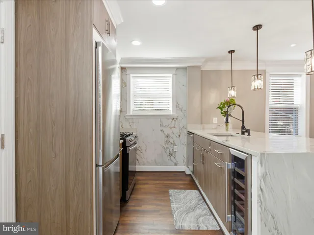 a kitchen with a sink and appliances