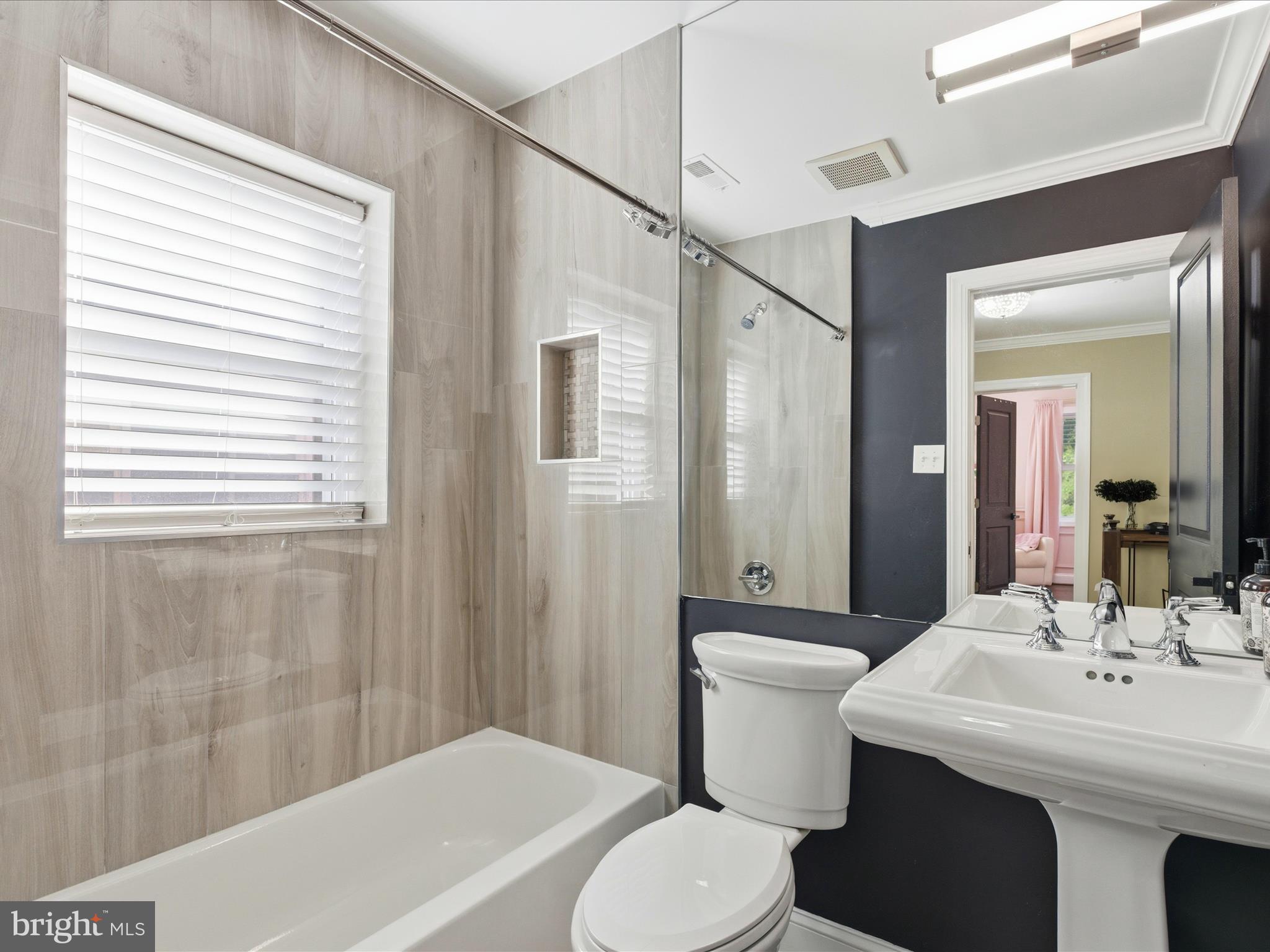 2717 Branch Avenue Southeast Washington, DC 20020 - Photo 17 of 51 a bathroom with a sink a toilet a mirror and a tub