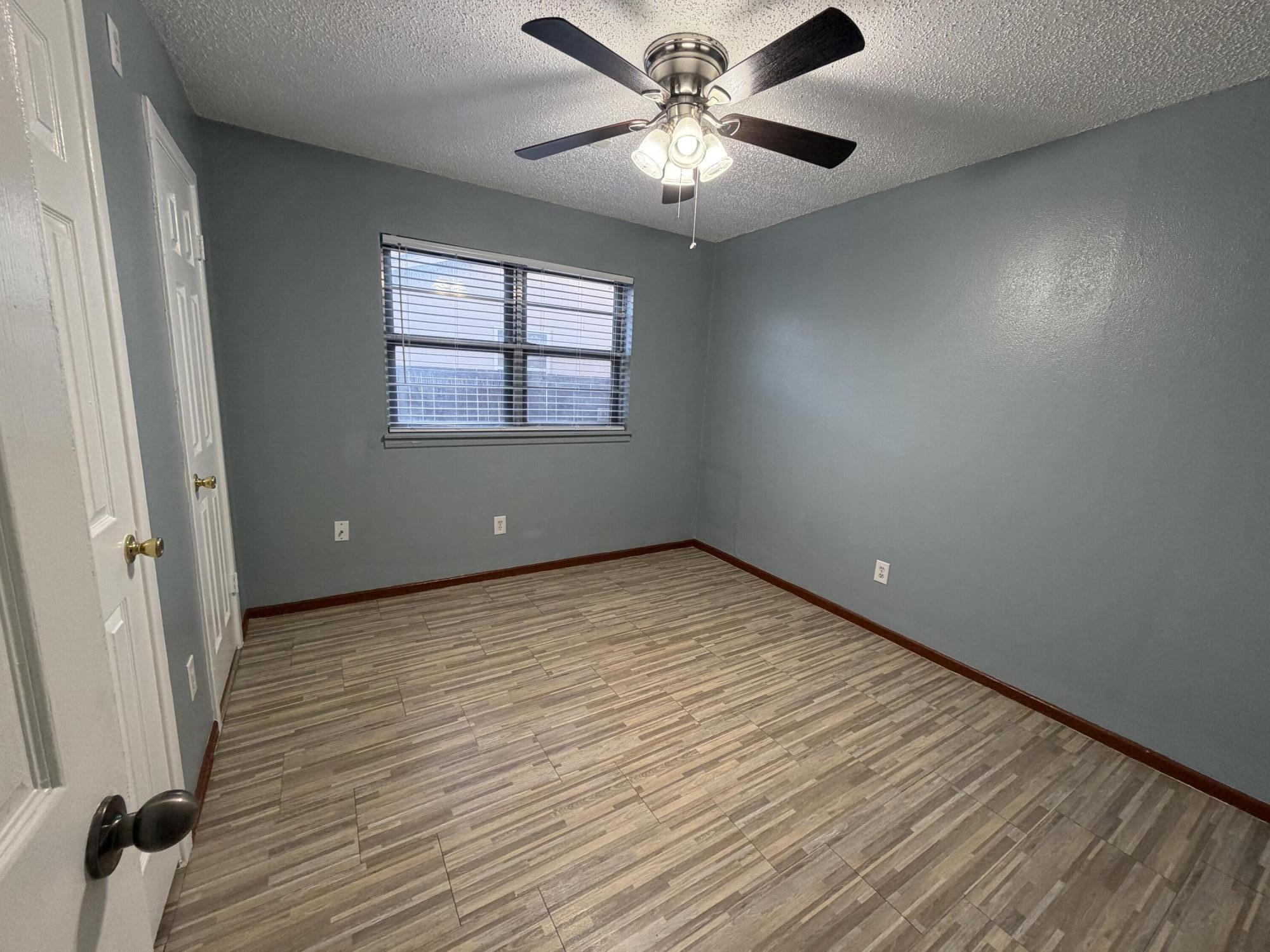5720 46th Street Lubbock, TX 79414 - Photo 16 of 23 an empty room with wooden floor and windows