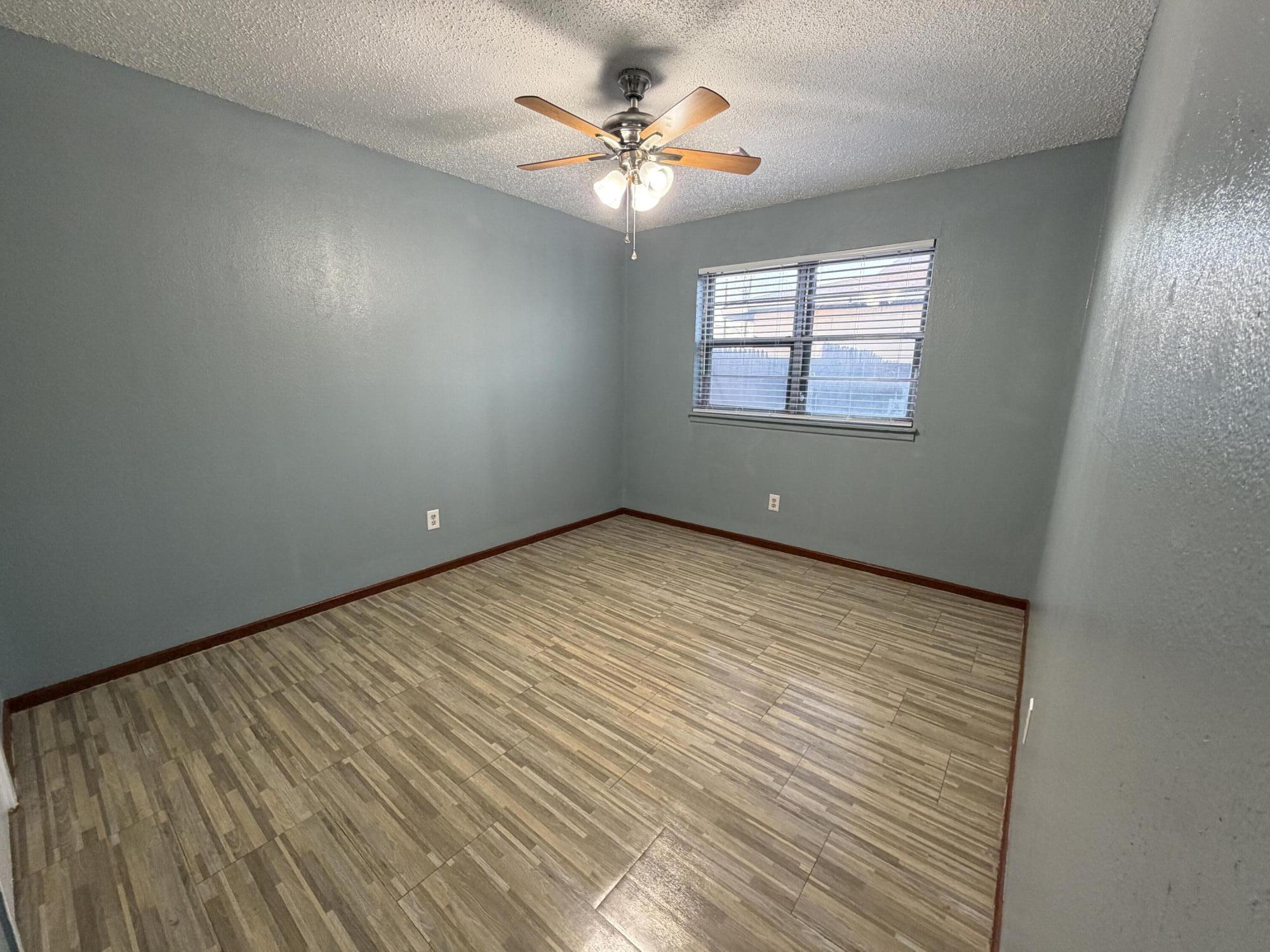 5720 46th Street Lubbock, TX 79414 - Photo 17 of 23 wooden floor in an empty room with a window