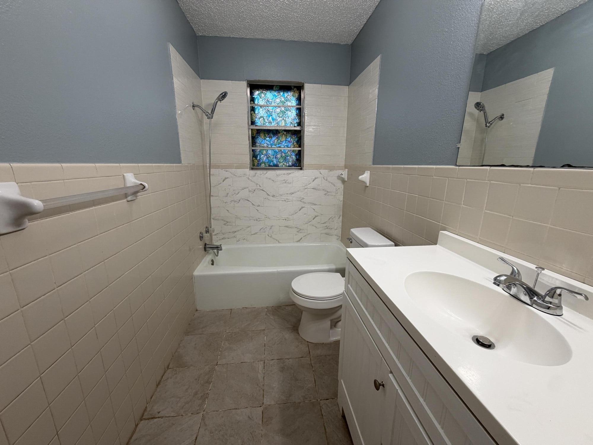 5720 46th Street Lubbock, TX 79414 - Photo 18 of 23 a bathroom with a sink a toilet and tub