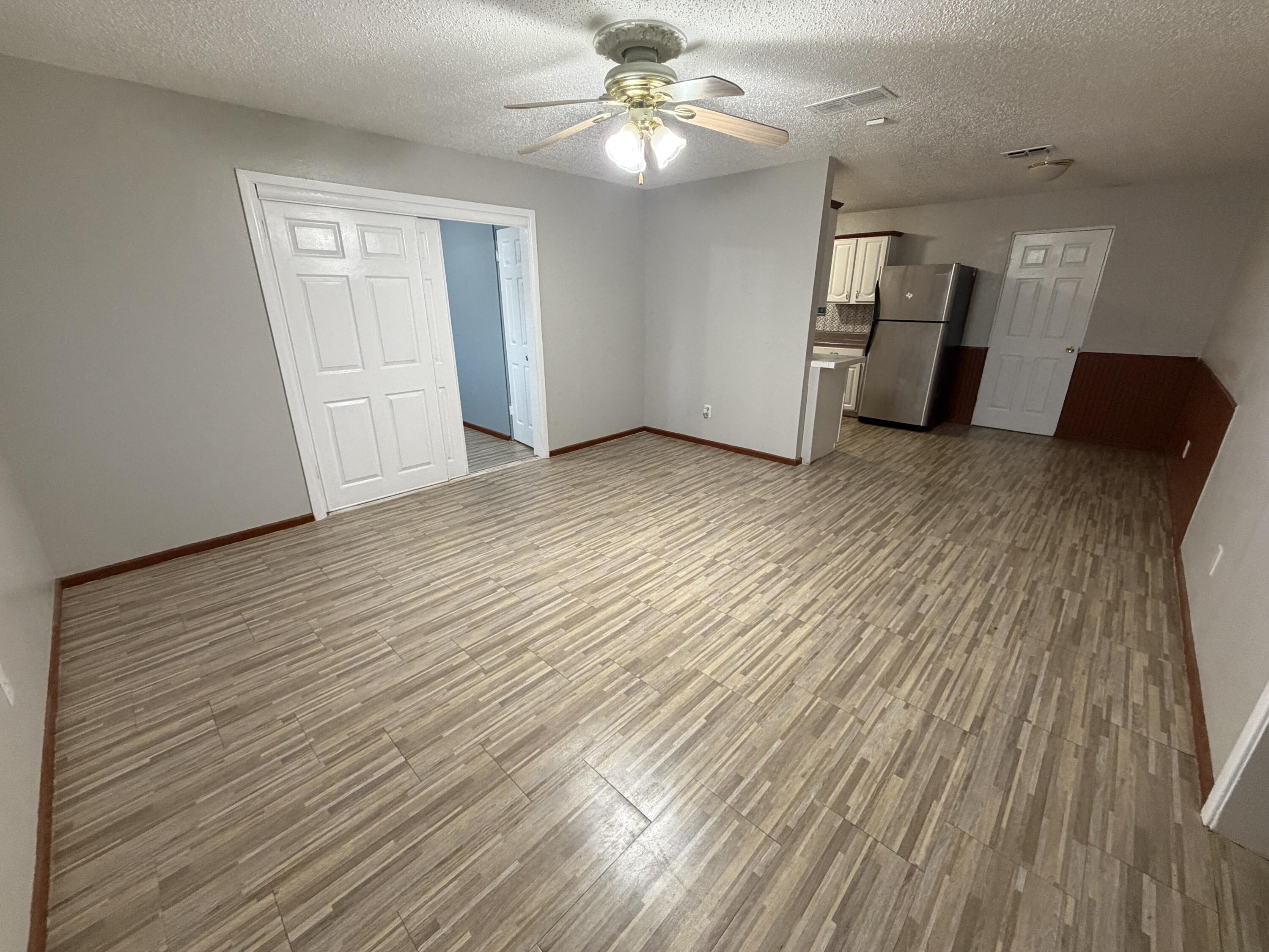 5720 46th Street Lubbock, TX 79414 - Photo 2 of 23 wooden floor in an empty room with a window