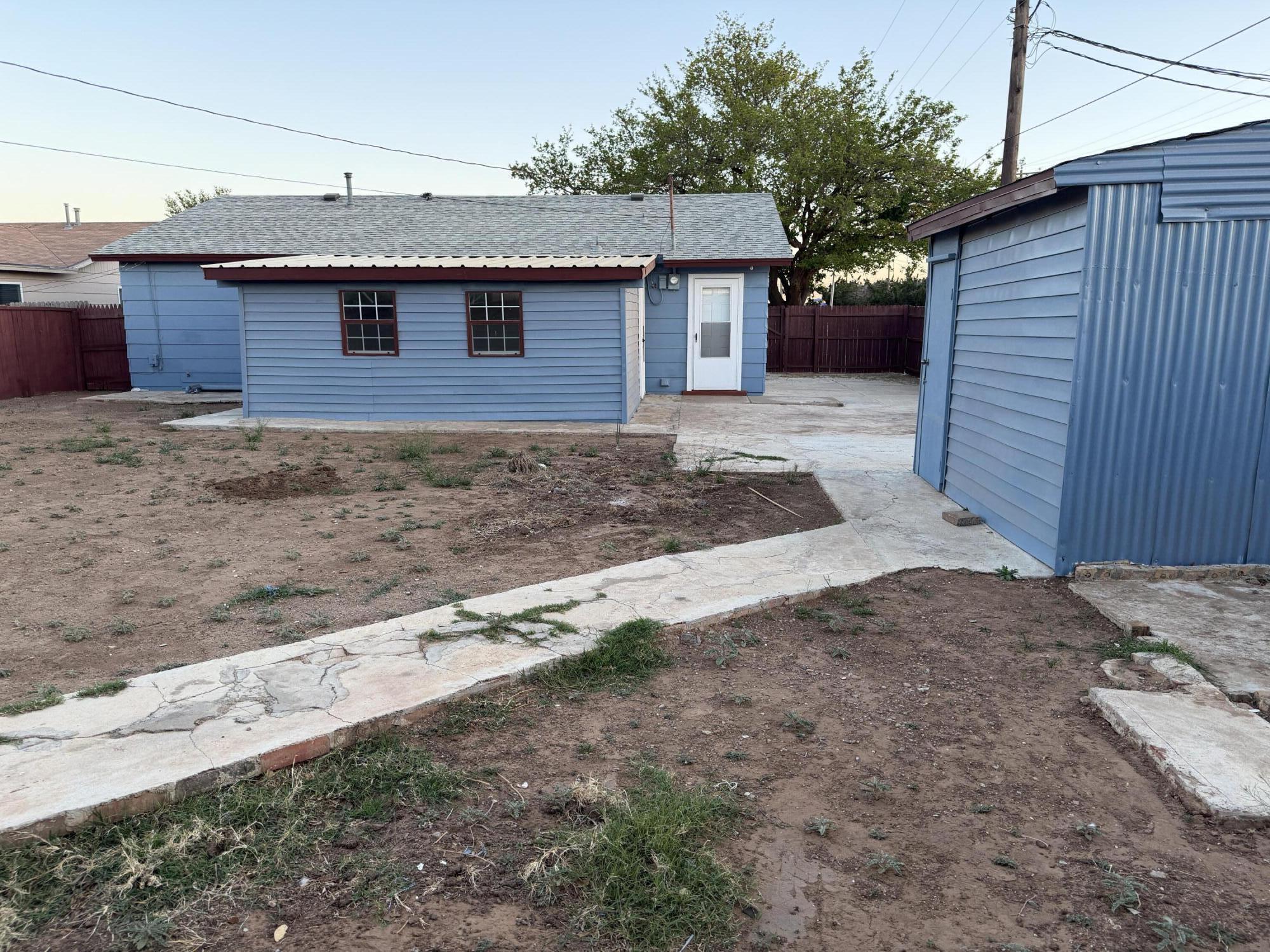 5720 46th Street Lubbock, TX 79414 - Photo 22 of 23 a front view of a house with garden