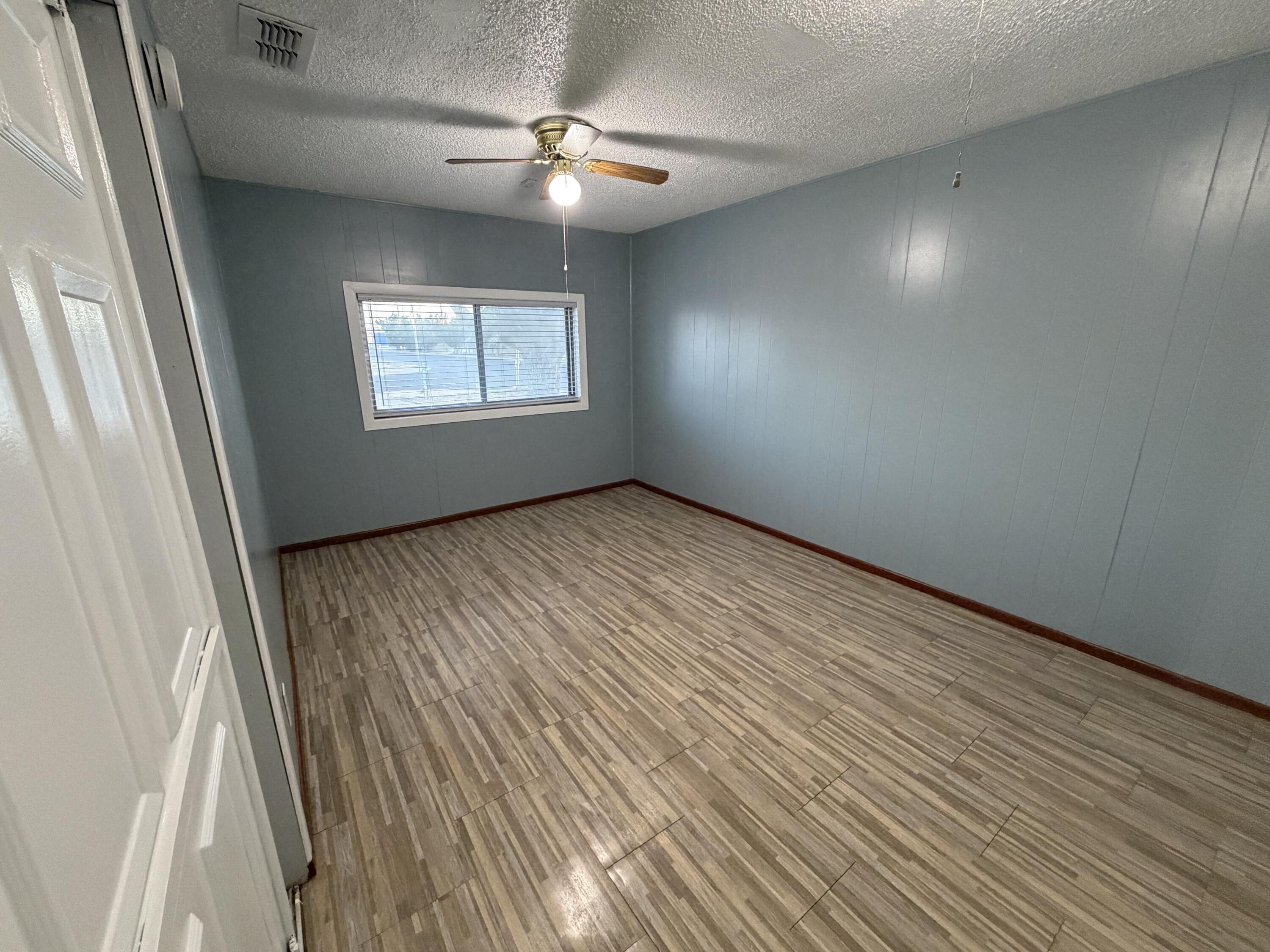 5720 46th Street Lubbock, TX 79414 - Photo 10 of 23 an empty room with windows and fan