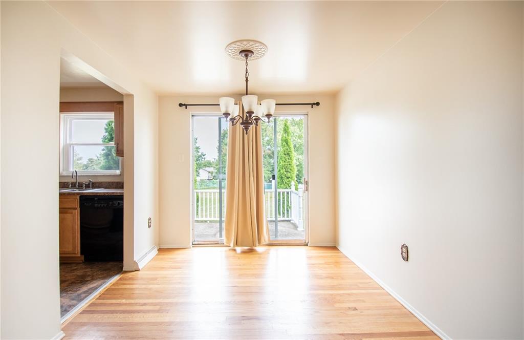 113 Newgate Drive Monaca, PA 15061 - Photo 4 of 18 a view of a hallway with wooden floor and a window