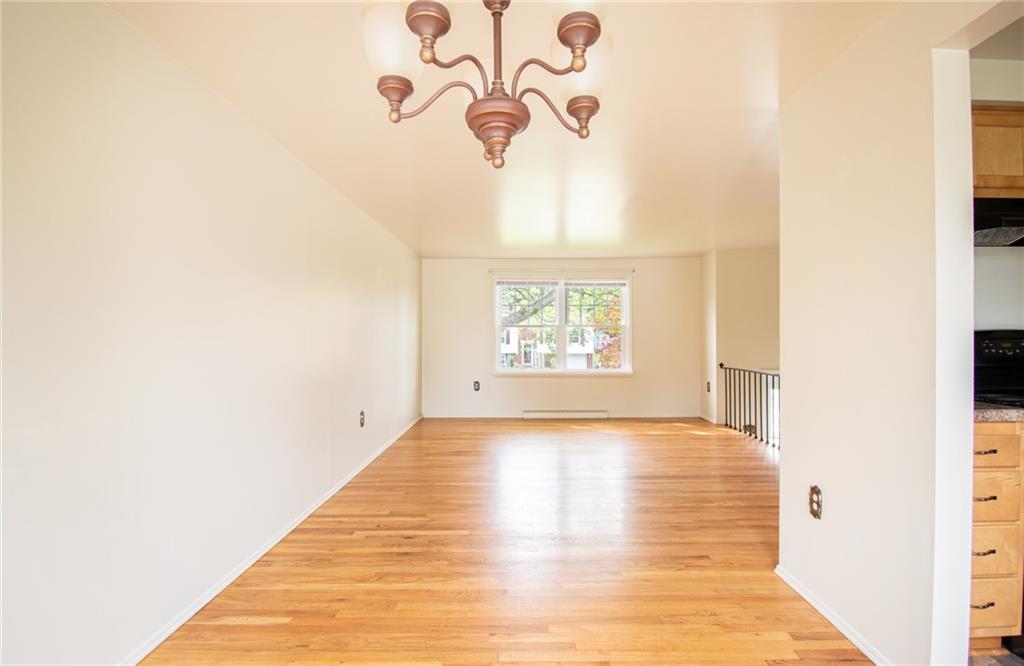 113 Newgate Drive Monaca, PA 15061 - Photo 5 of 18 a view of an empty room with wooden floor and a window