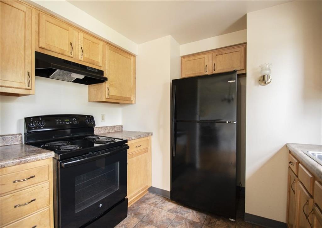 113 Newgate Drive Monaca, PA 15061 - Photo 7 of 18 a kitchen with stainless steel appliances granite countertop a refrigerator and a stove