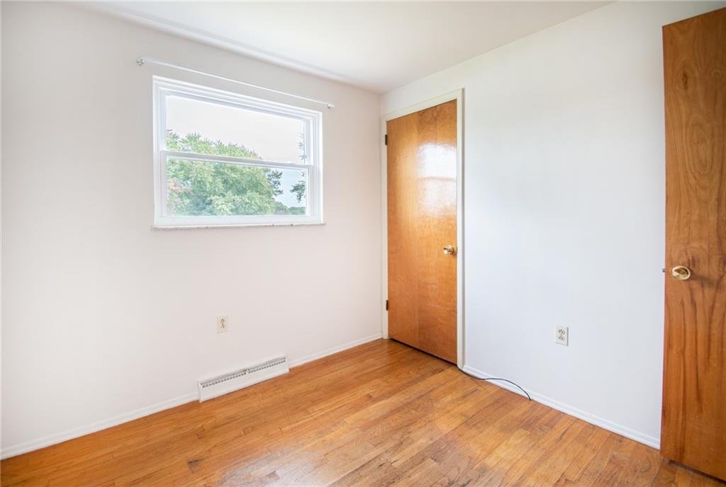 113 Newgate Drive Monaca, PA 15061 - Photo 8 of 18 a view of an empty room with wooden floor and a window