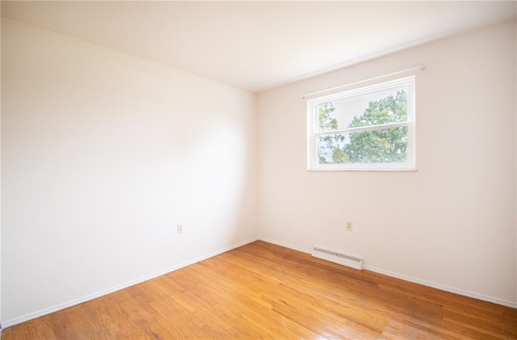 113 Newgate Drive Monaca, PA 15061 - Photo 9 of 18 an empty room with wooden floor and windows