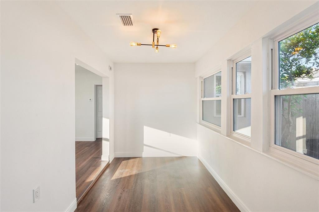 410 Virginia Avenue Madeira Beach, FL 33708 - Photo 12 of 25 a view of an empty room with wooden floor and a window