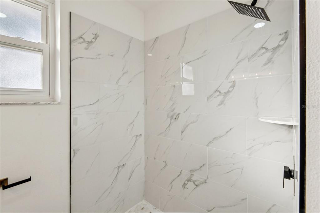 410 Virginia Avenue Madeira Beach, FL 33708 - Photo 14 of 25 a bathroom with a shower