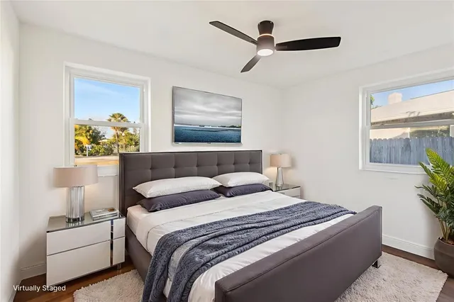 a bedroom with bed and a painting on the wall