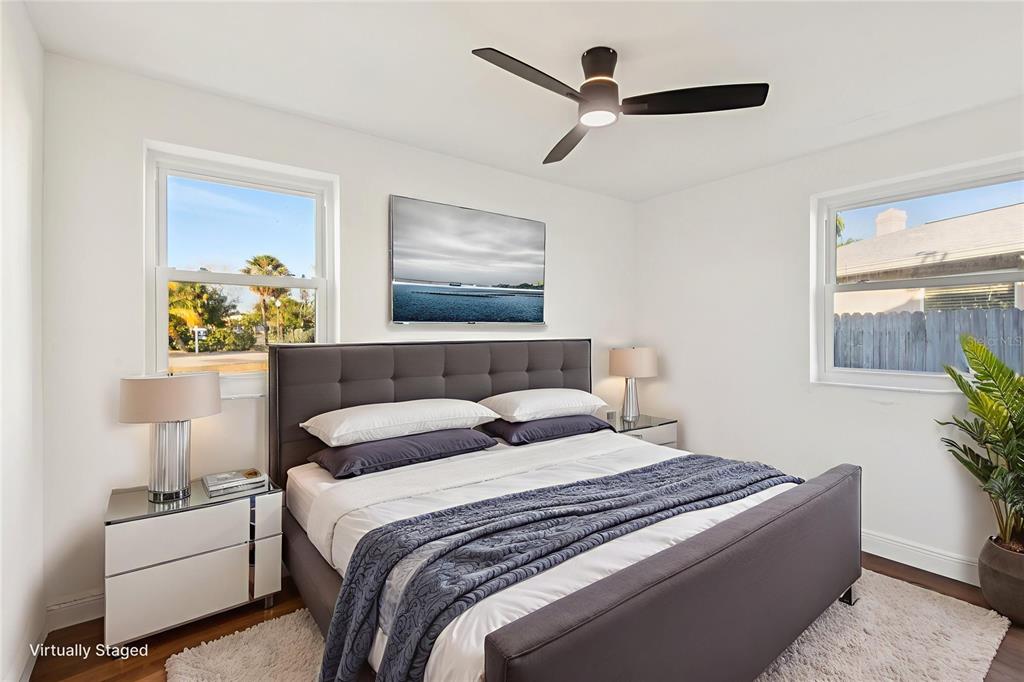 410 Virginia Avenue Madeira Beach, FL 33708 - Photo 16 of 25 a bedroom with bed and a painting on the wall