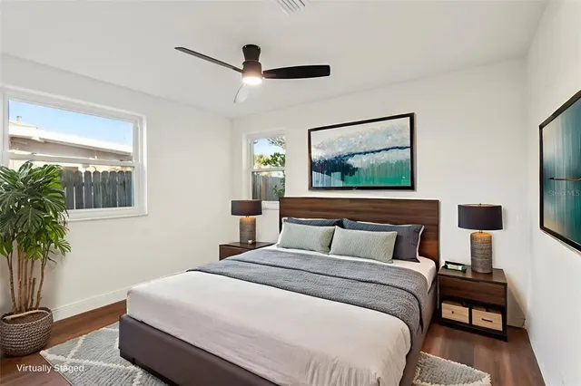 a bedroom with a large bed and a potted plant