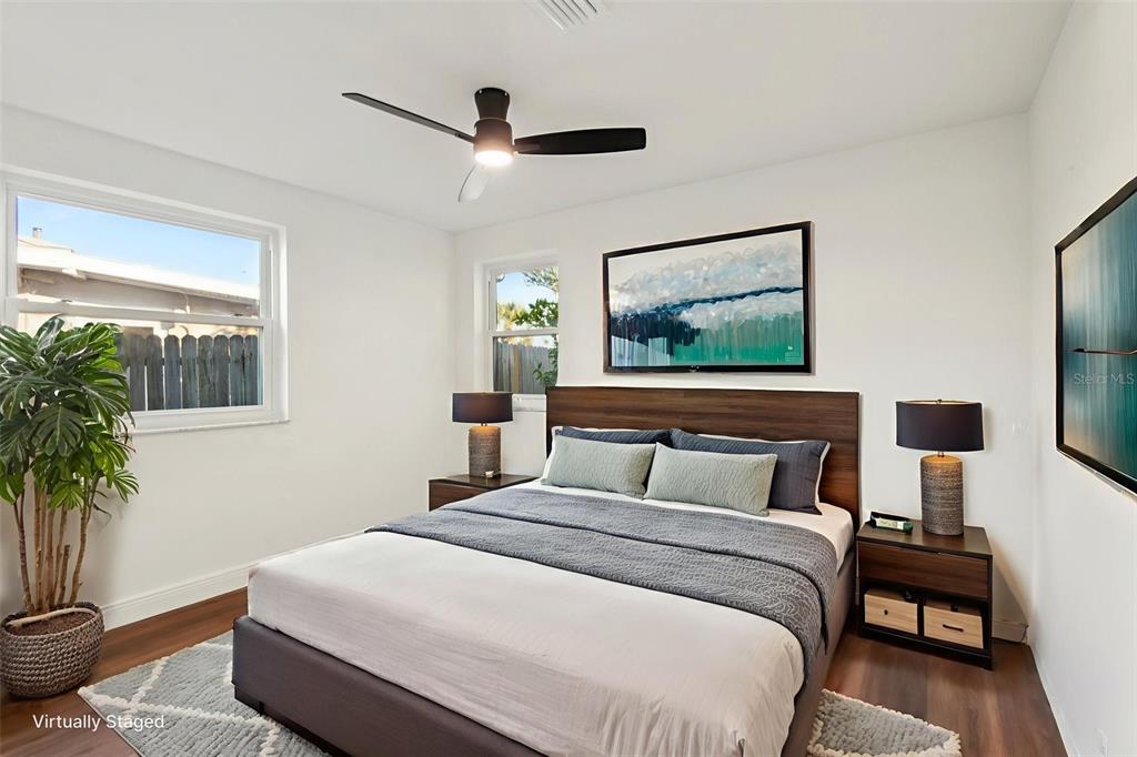 410 Virginia Avenue Madeira Beach, FL 33708 - Photo 18 of 25 a bedroom with a large bed and a potted plant