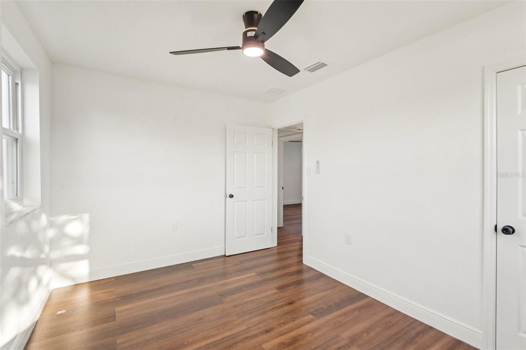 410 Virginia Avenue Madeira Beach, FL 33708 - Photo 19 of 25 a view of an empty room with wooden floor and a window