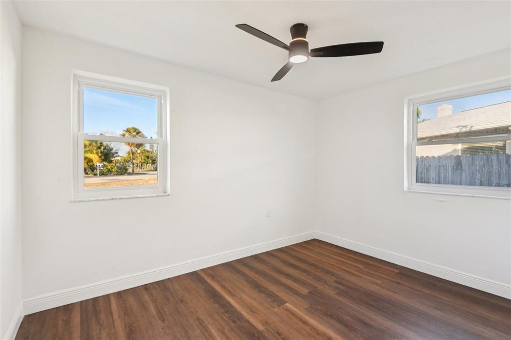 410 Virginia Avenue Madeira Beach, FL 33708 - Photo 20 of 25 a view of a hallway with wooden floor and a window