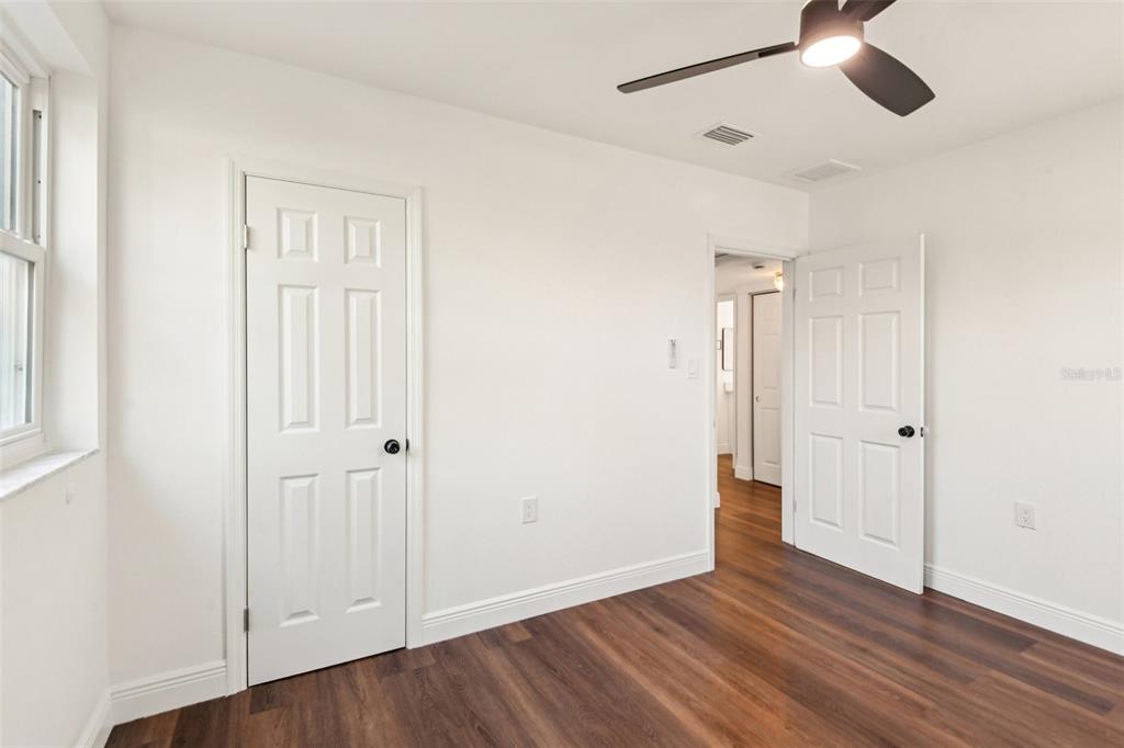 410 Virginia Avenue Madeira Beach, FL 33708 - Photo 21 of 25 a view of an empty room with wooden floor