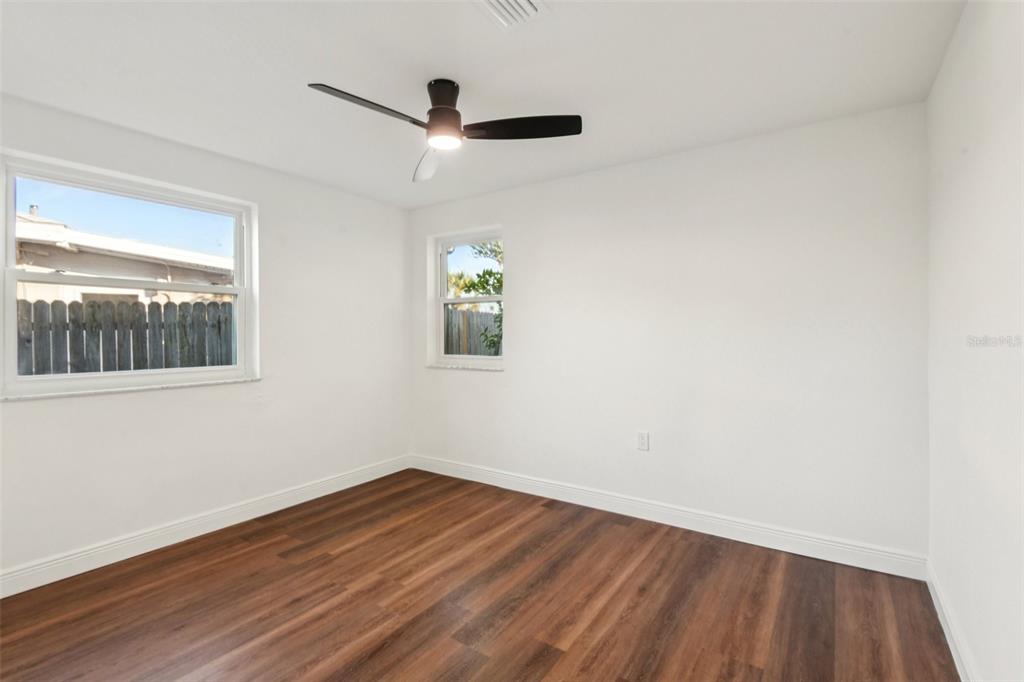 410 Virginia Avenue Madeira Beach, FL 33708 - Photo 22 of 25 wooden floor in an empty room with a window