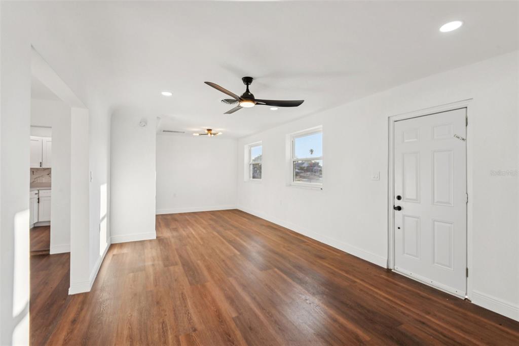 410 Virginia Avenue Madeira Beach, FL 33708 - Photo 4 of 25 wooden floor in an empty room with a window