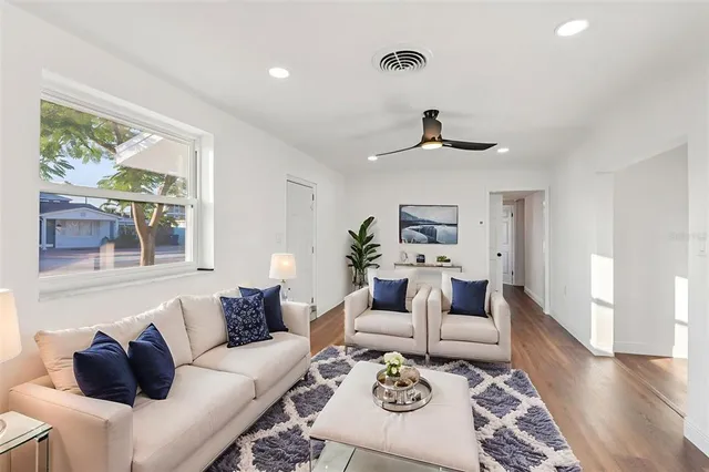 a living room with furniture and a large window