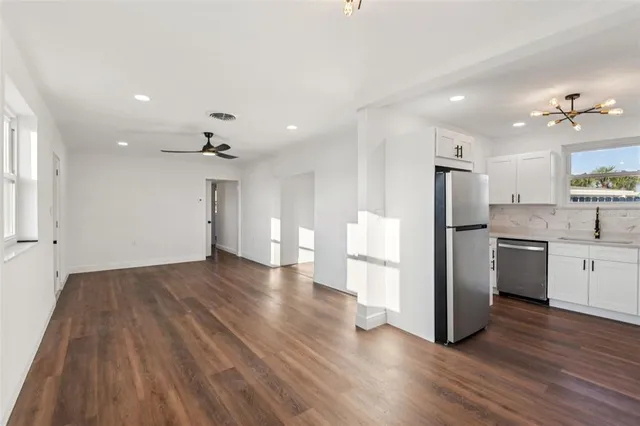 a kitchen with a refrigerator and a stove top oven