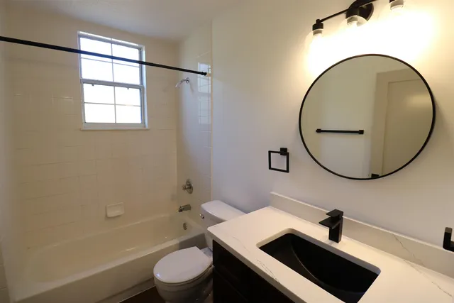 a bathroom with a sink a toilet and a mirror