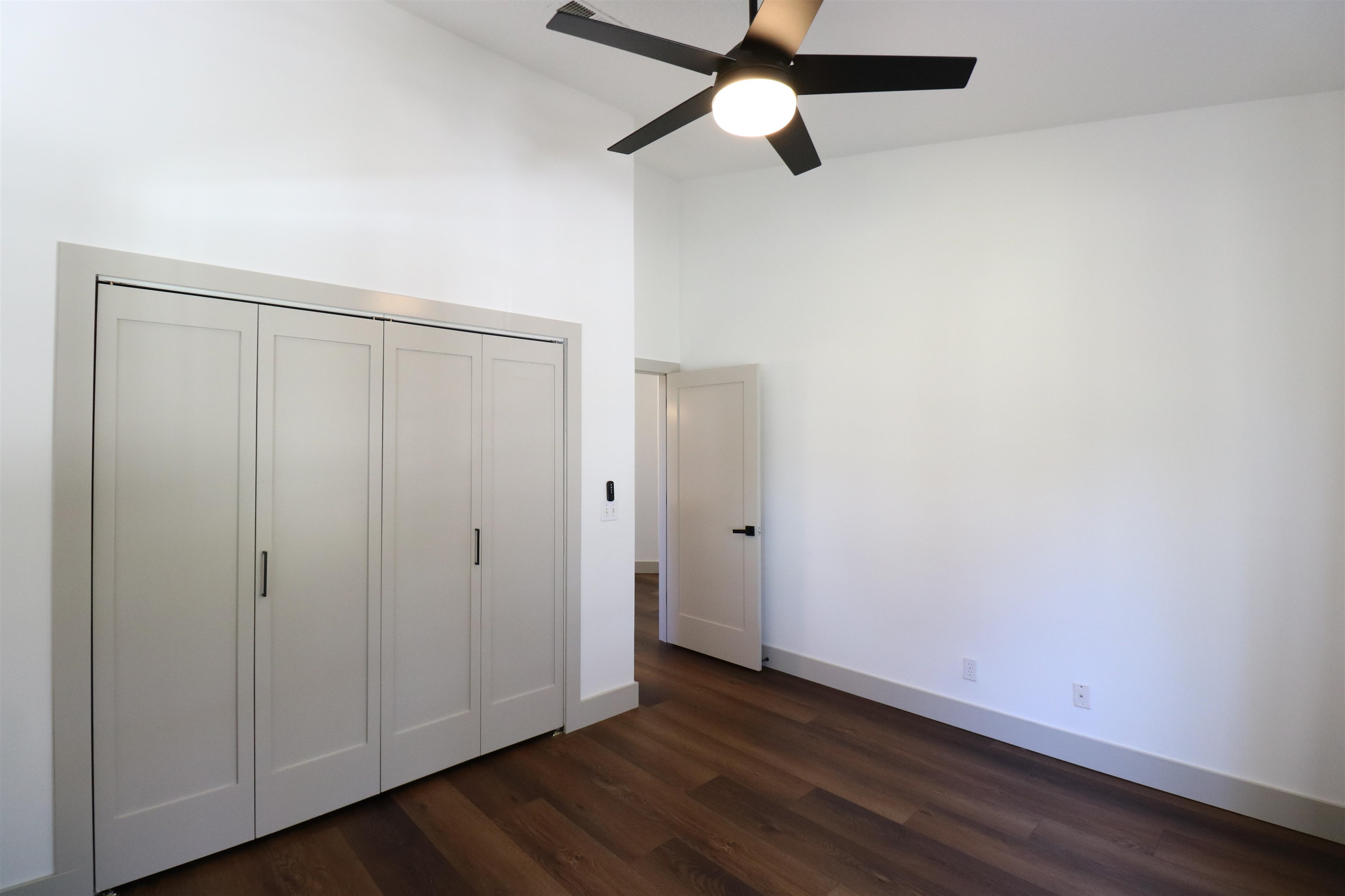 613 Augusta Circle St. Augustine, FL 32086 - Photo 21 of 26 an empty room with wooden floor closet fan and windows