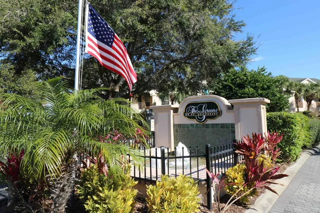 a front view of a house with a yard and sitting area