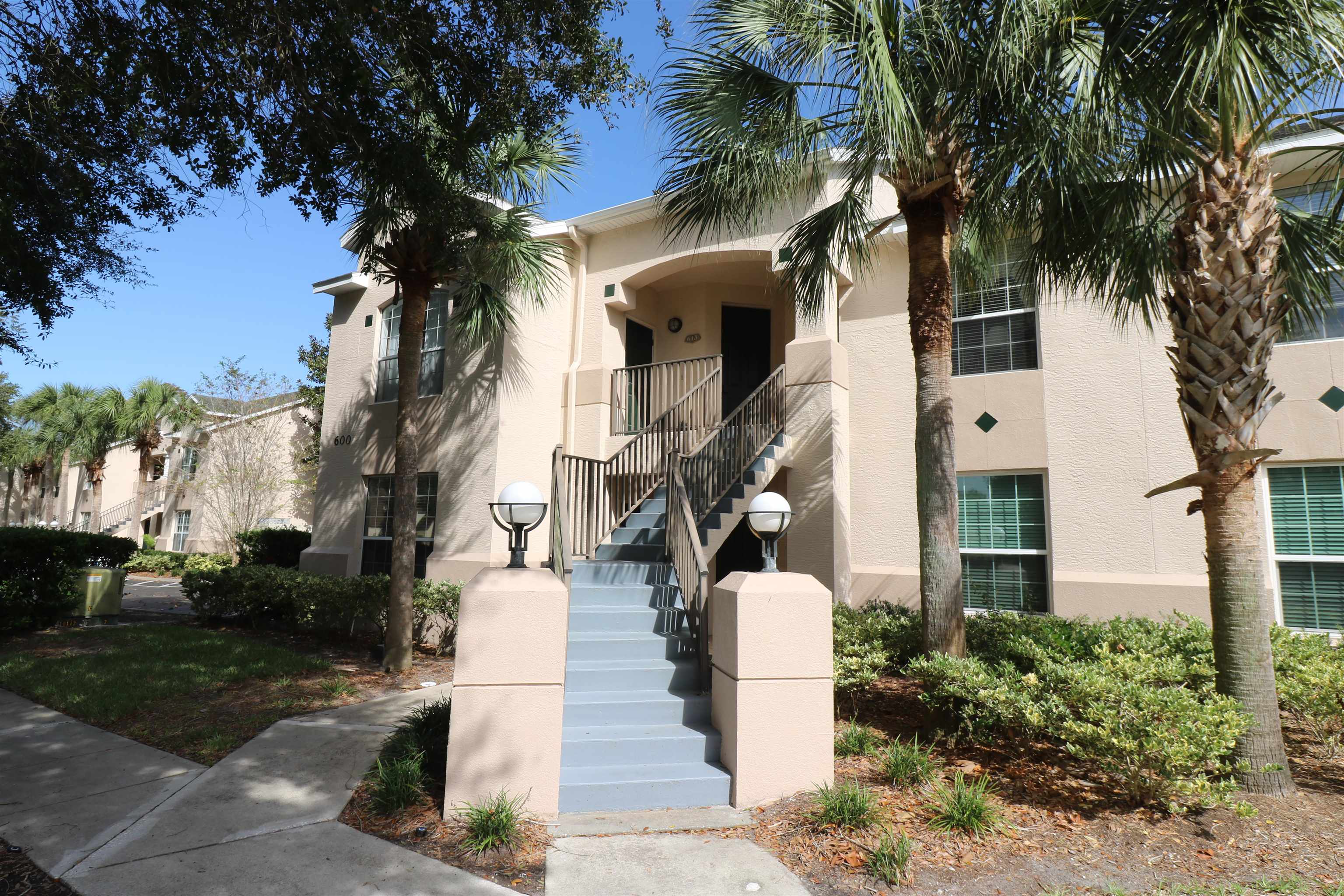 613 Augusta Circle St. Augustine, FL 32086 - Photo 23 of 26 a front view of a house with a garden