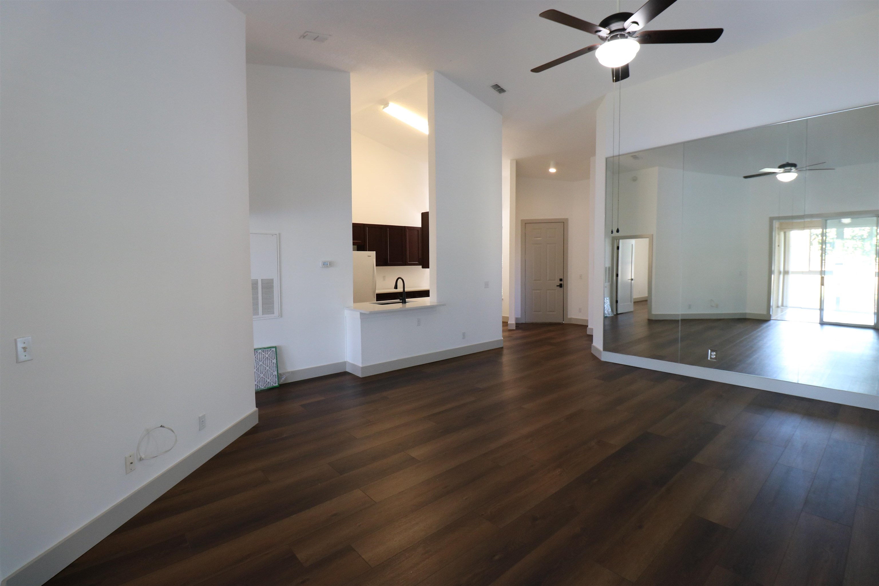 613 Augusta Circle St. Augustine, FL 32086 - Photo 3 of 26 wooden floor in an empty room with a window