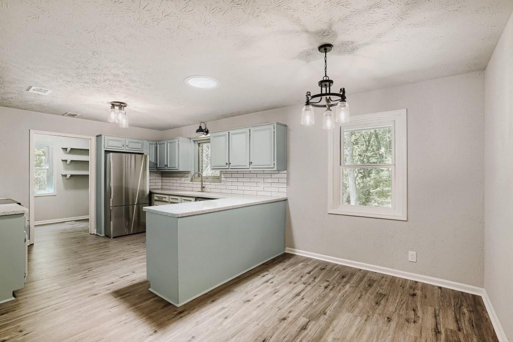 2021 Irwin Bridge Road Northwest Conyers, GA 30012 - Photo 10 of 43 a kitchen with stainless steel appliances granite countertop a sink stove and refrigerator