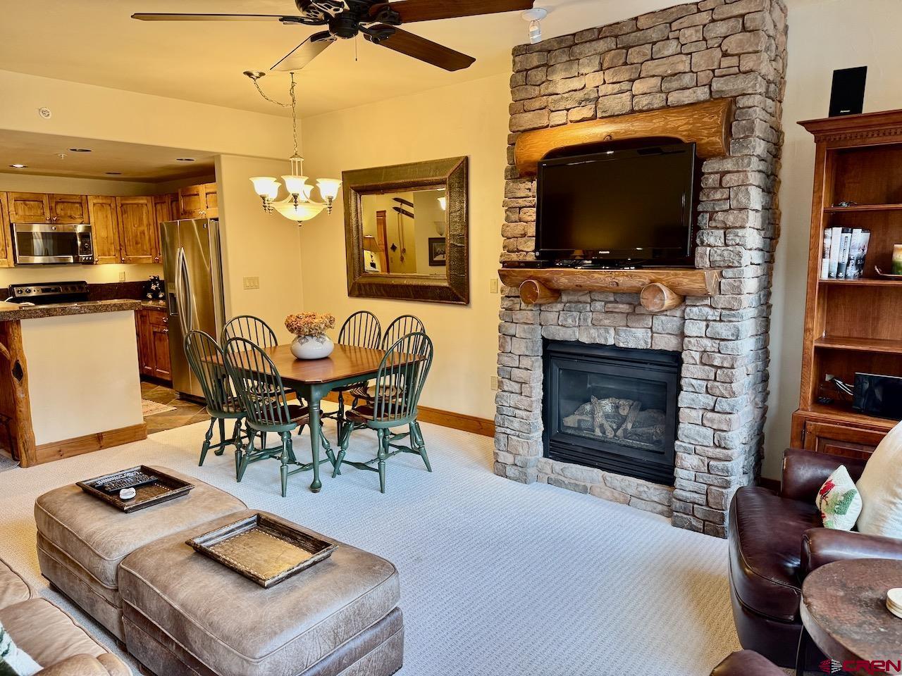 9 Hunter Hill Road, Unit 205 Crested Butte, CO 81225 - Photo 9 of 28 a living room with furniture a flat screen tv and a fireplace