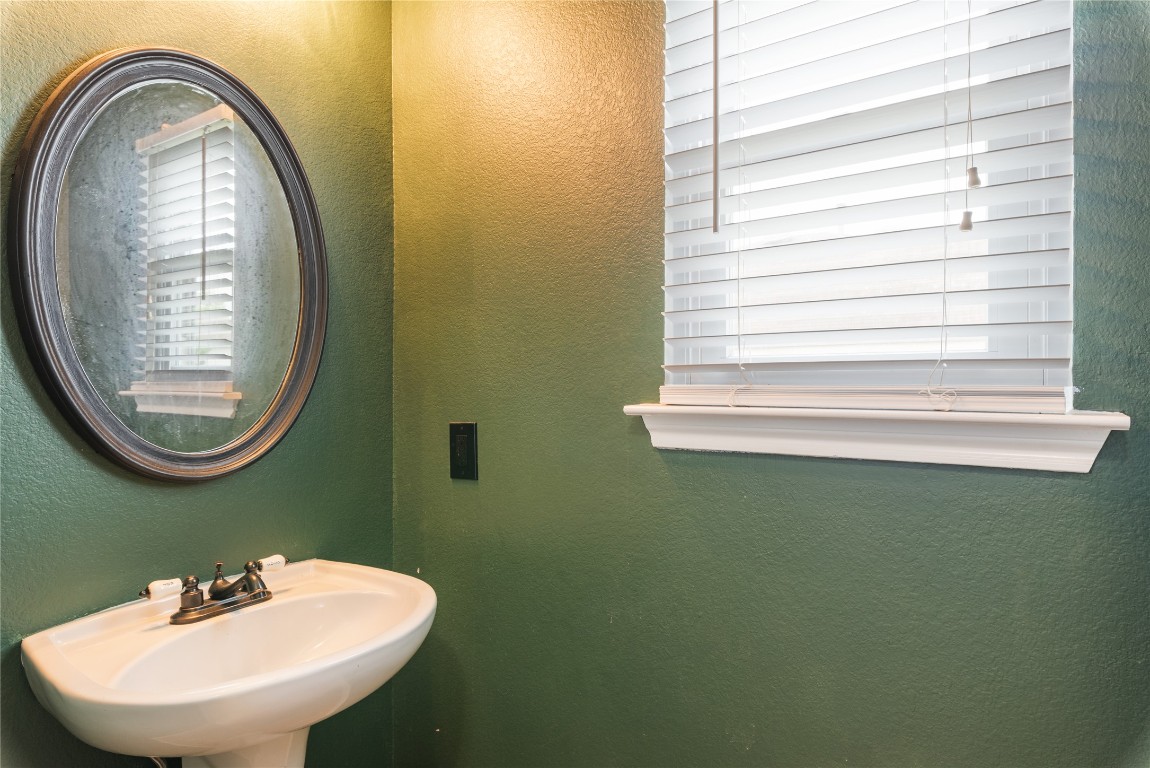 1329 Amberwood Loop Kyle, TX 78640 - Photo 11 of 25 a bathroom with a sink and a mirror