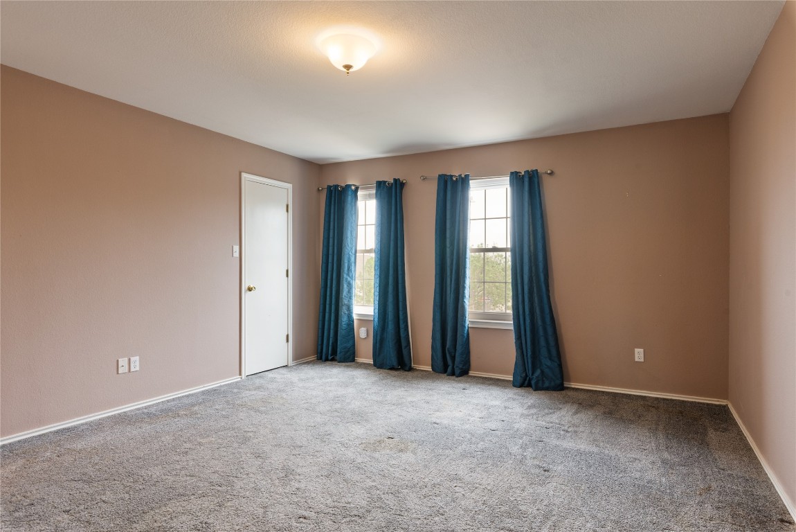 1329 Amberwood Loop Kyle, TX 78640 - Photo 17 of 25 an empty room with windows and closet