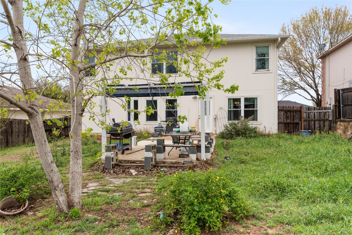 1329 Amberwood Loop Kyle, TX 78640 - Photo 23 of 25 a view of a house with backyard sitting area and garden