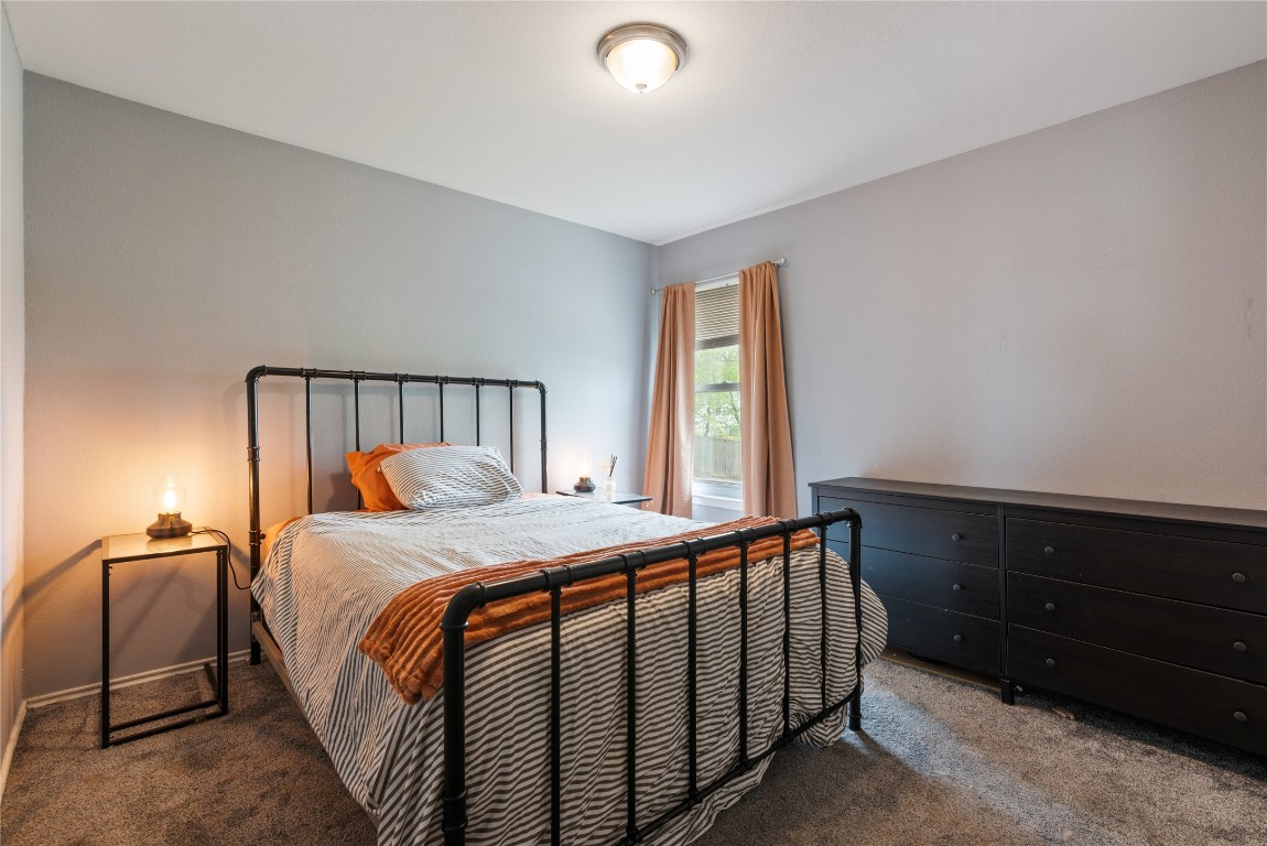 1329 Amberwood Loop Kyle, TX 78640 - Photo 4 of 25 a bedroom with a bed and a window