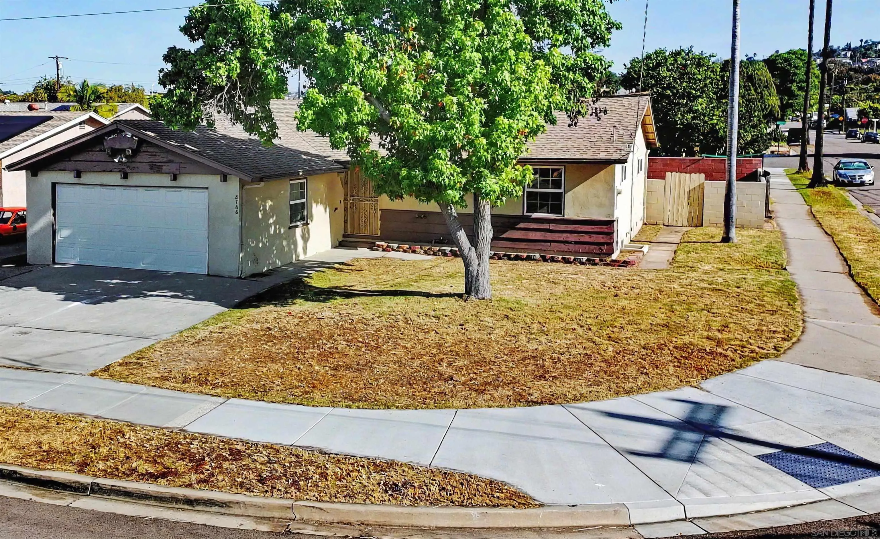 a view of a house with wooden fence