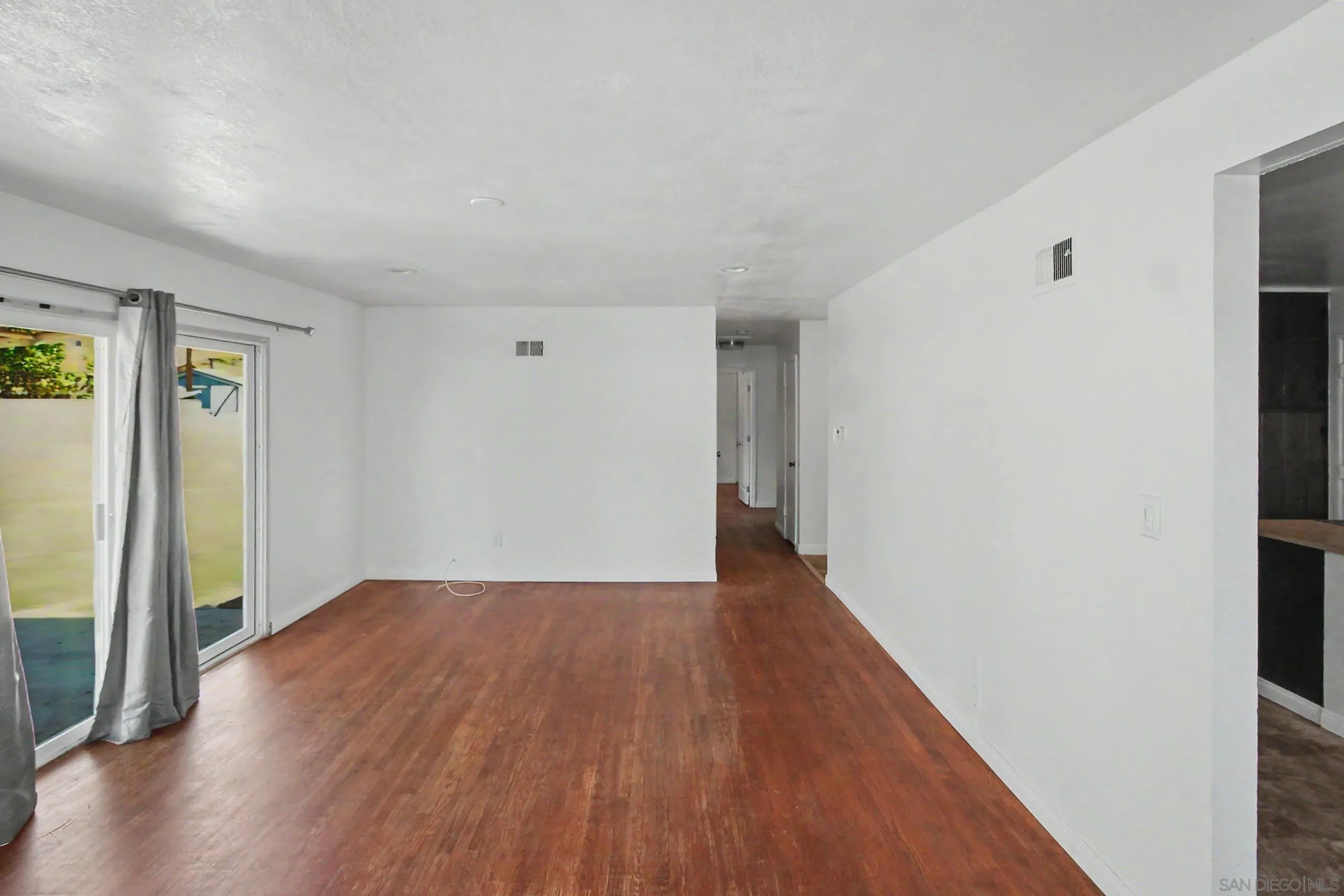 8766 Kelso Street Spring Valley, CA 91977 - Photo 12 of 44 a view of an empty room with wooden floor