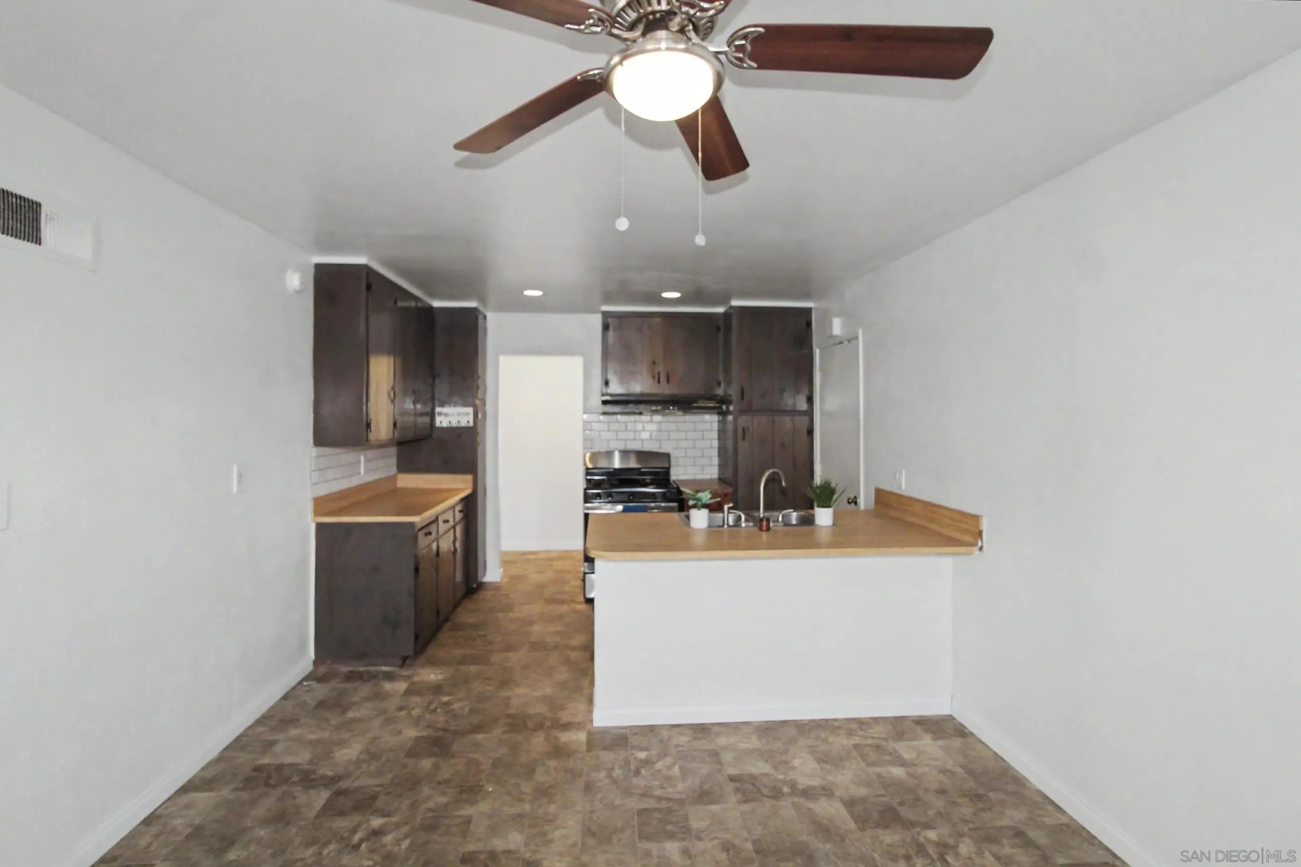 8766 Kelso Street Spring Valley, CA 91977 - Photo 15 of 44 a view of a kitchen with a sink and microwave