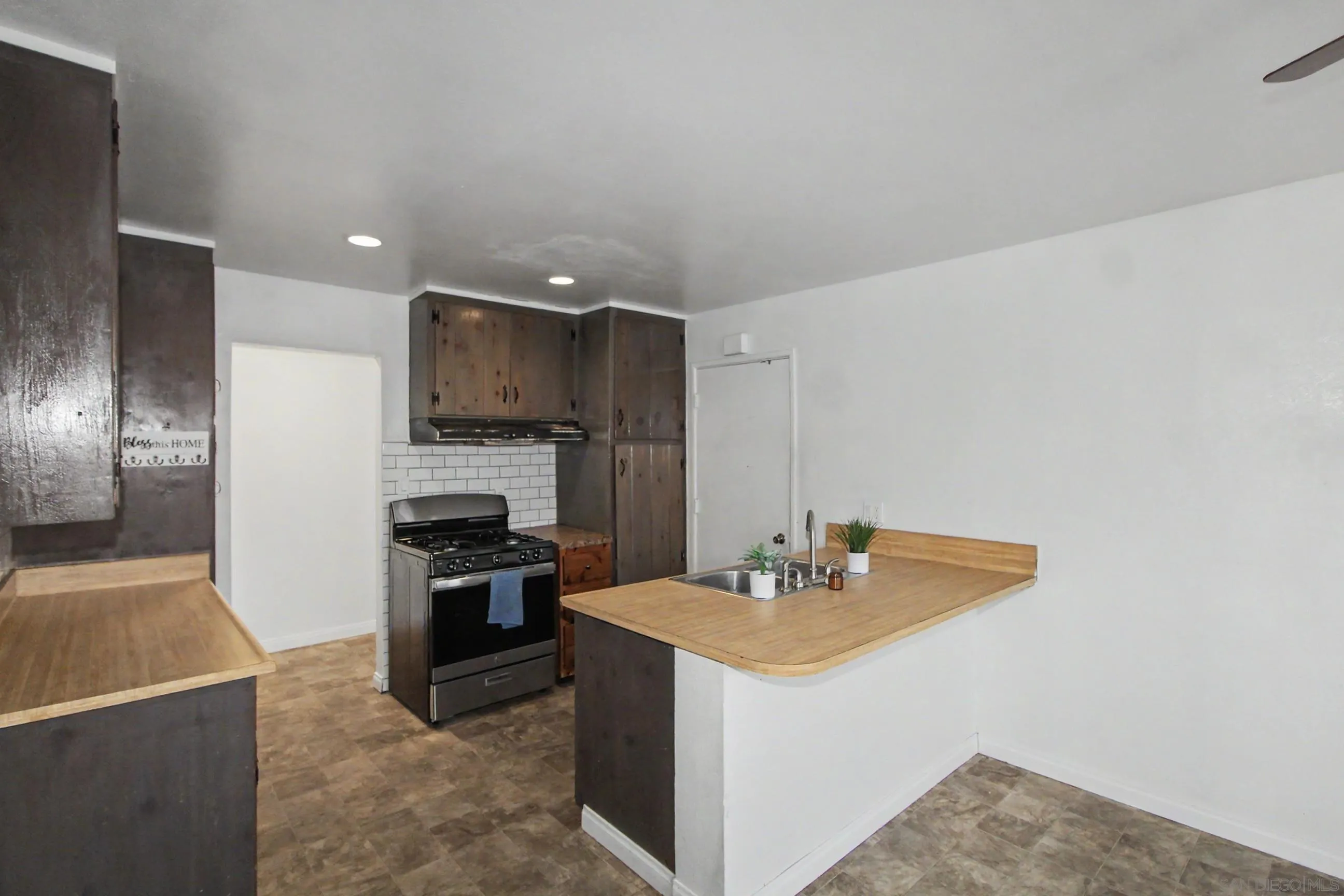 8766 Kelso Street Spring Valley, CA 91977 - Photo 16 of 44 a kitchen with a sink cabinets and stainless steel appliances