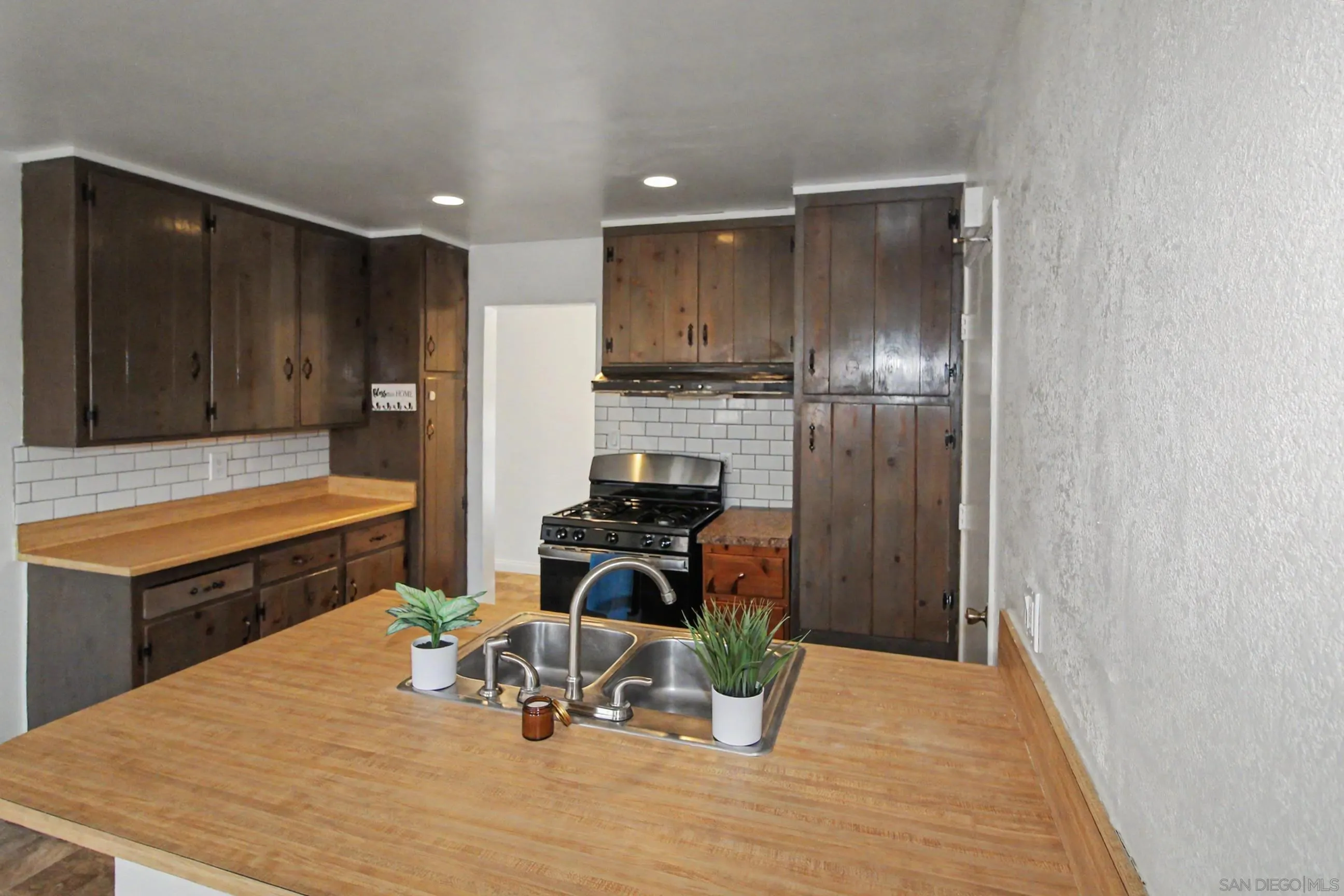 8766 Kelso Street Spring Valley, CA 91977 - Photo 17 of 44 a kitchen with a refrigerator and a stove top oven