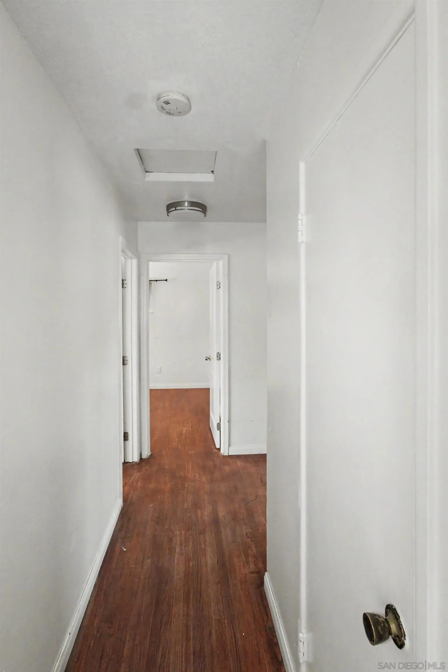 8766 Kelso Street Spring Valley, CA 91977 - Photo 18 of 44 a view of a hallway with wooden floor