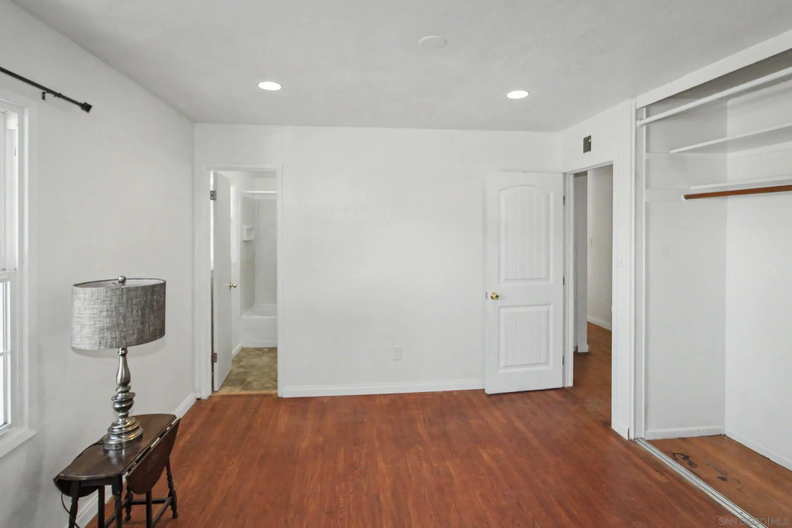 8766 Kelso Street Spring Valley, CA 91977 - Photo 22 of 44 a view of a bedroom with a bed and wooden floor