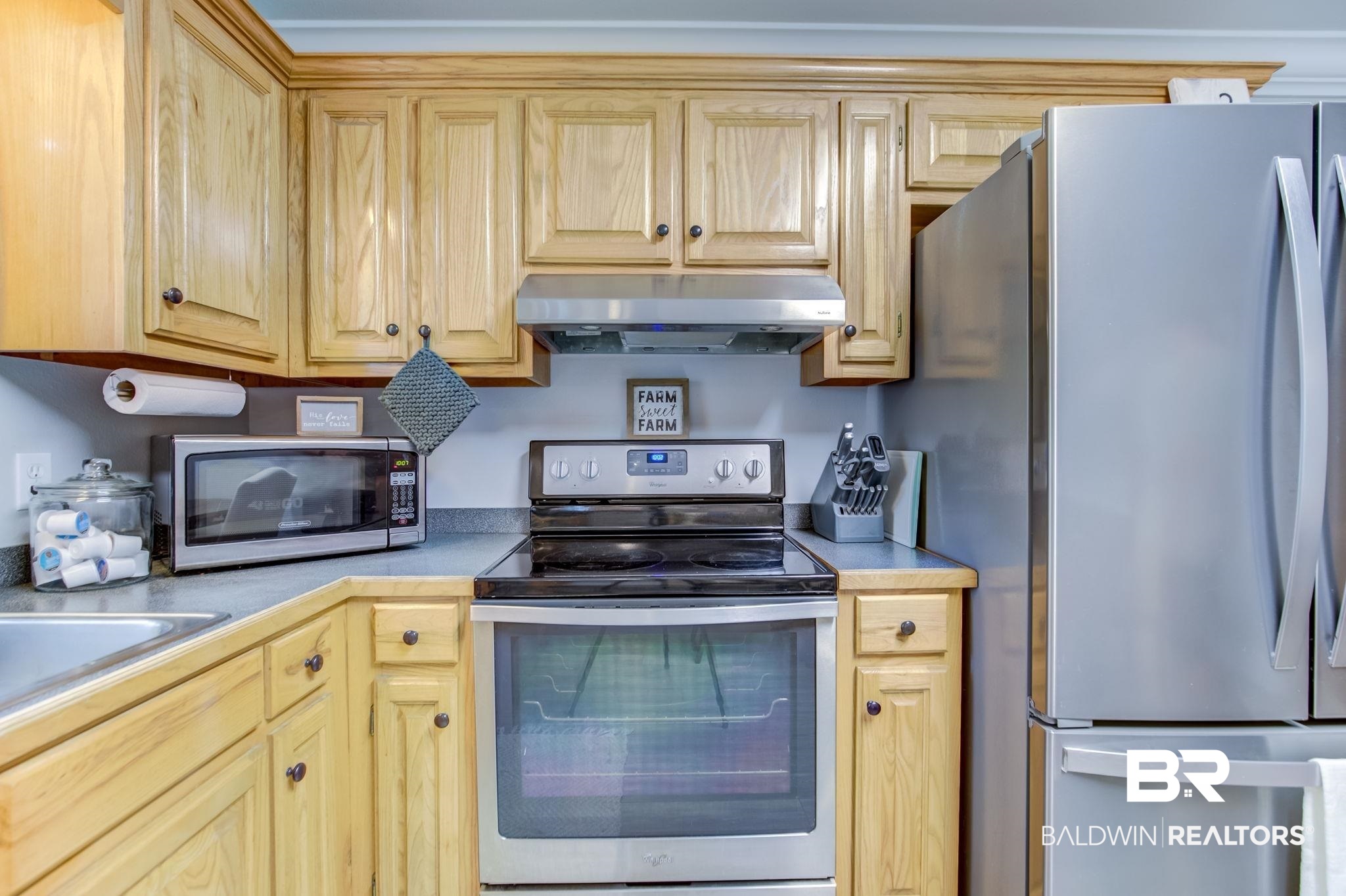 18732 Fairground Road Robertsdale, AL 36567 - Photo 15 of 46 Kitchen with appliances with stainless steel finishes and light brown cabinetry