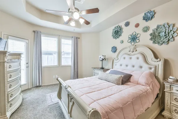 a bedroom with a large bed and a window