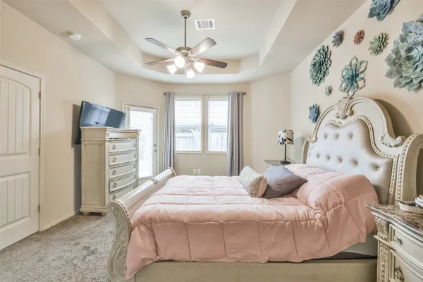 a bedroom with a bed and a chandelier