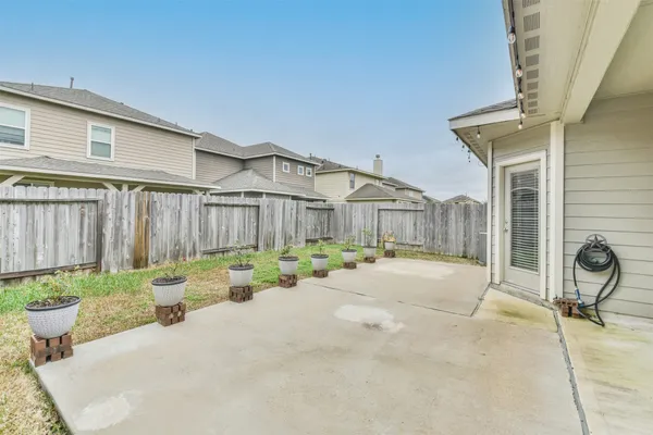 a front view of house with a garden and patio